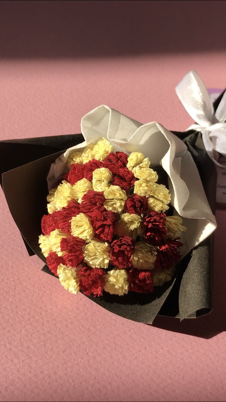 Close-up of red and ivory handmade paper dahlias