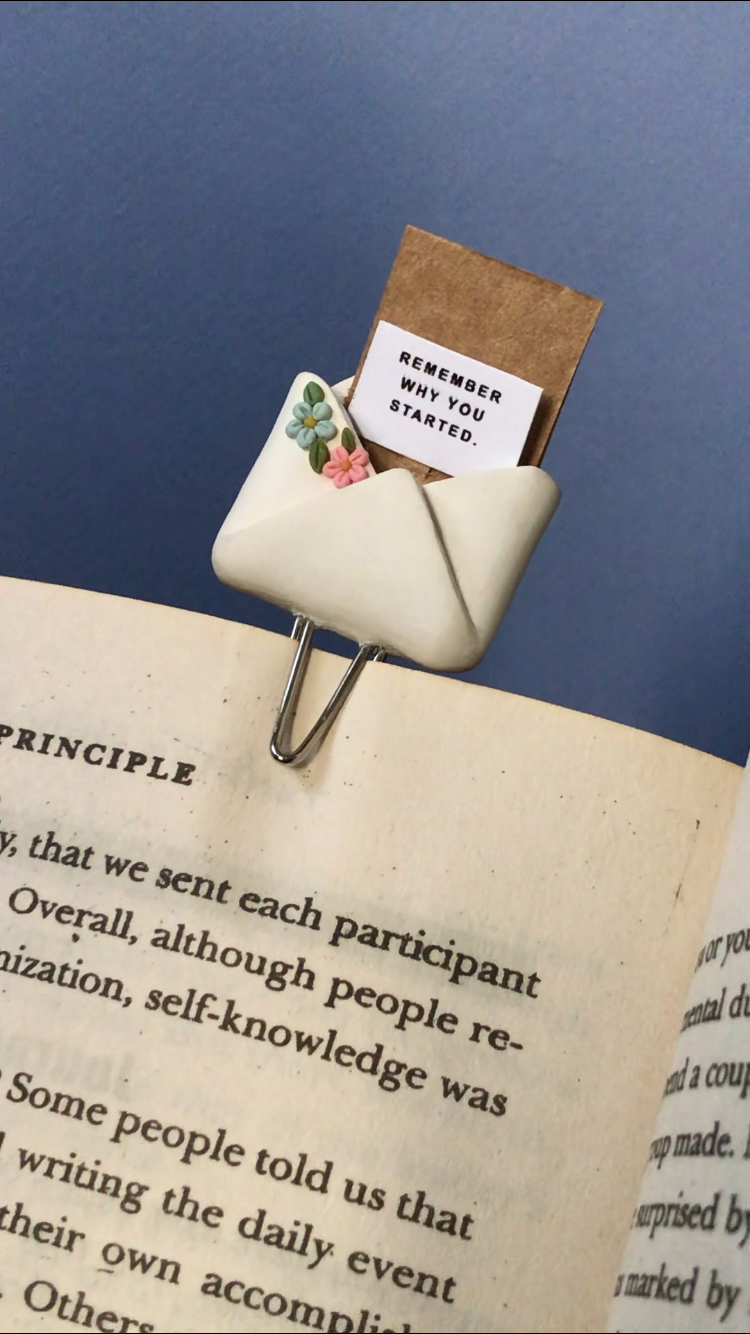 Flopey bookmark clipped to book with Remember Why You Started note