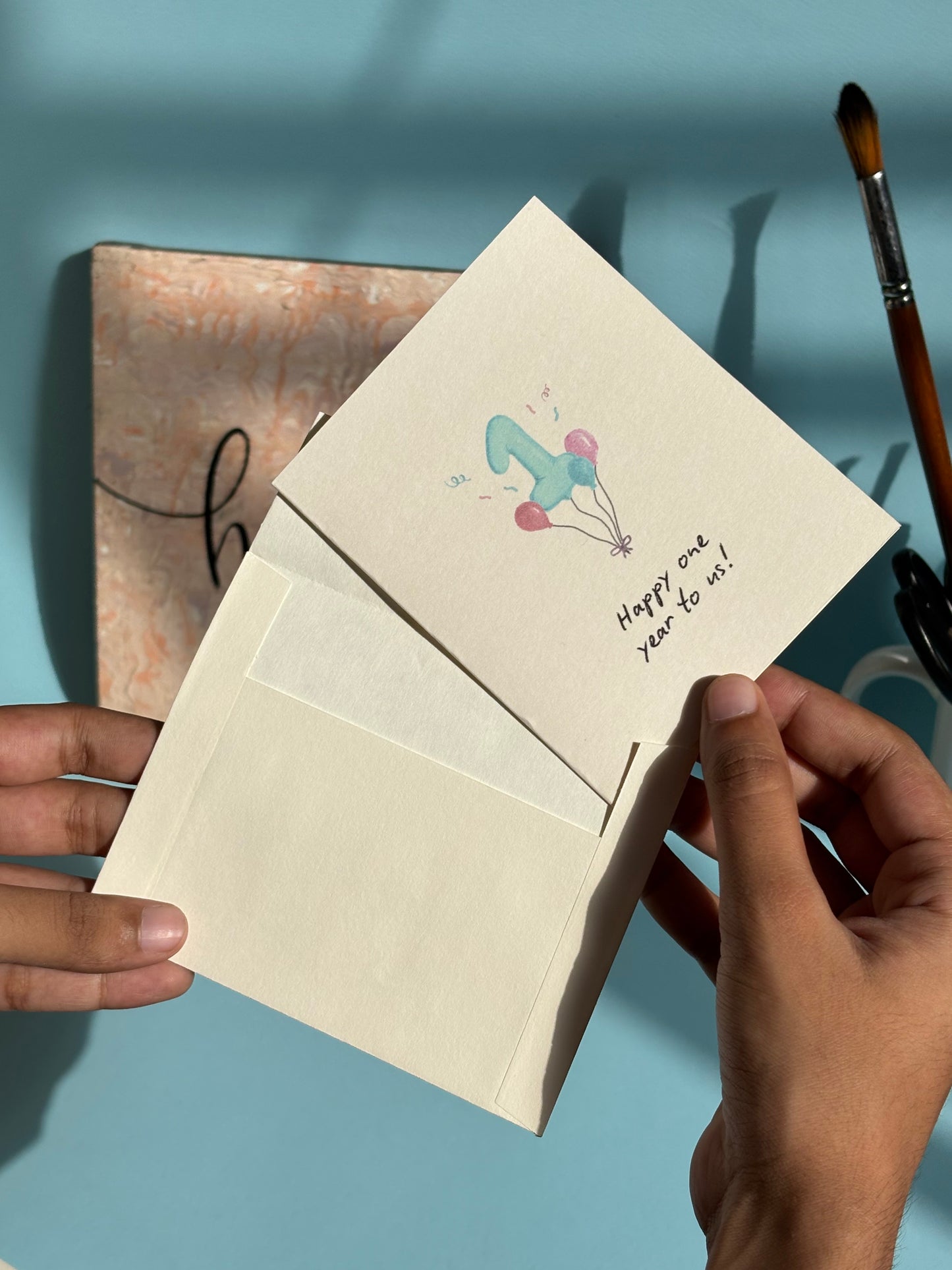 Happy one year anniversary greeting card shown with matching envelope