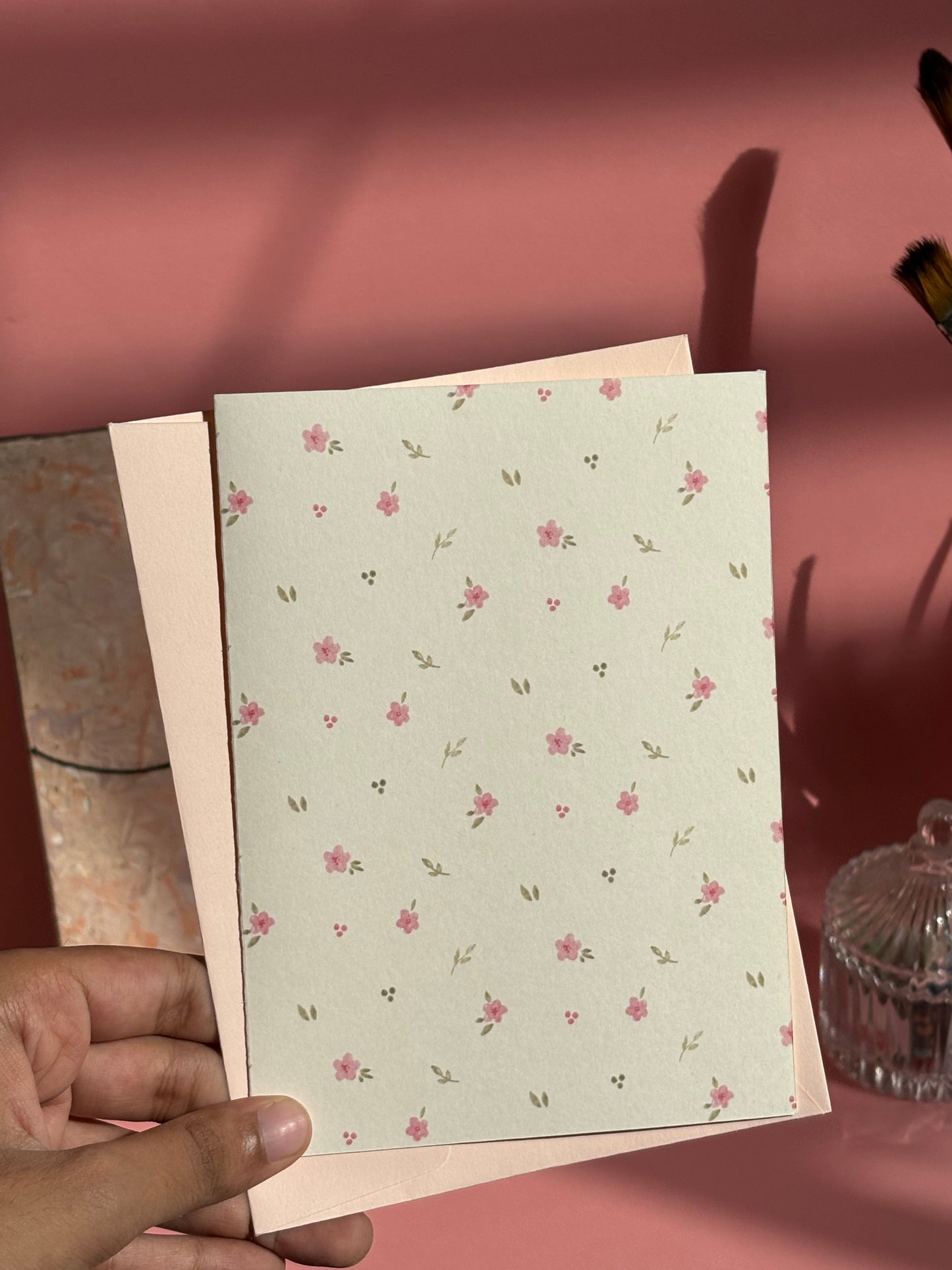 Pink floral greeting card with delicate scattered flower pattern