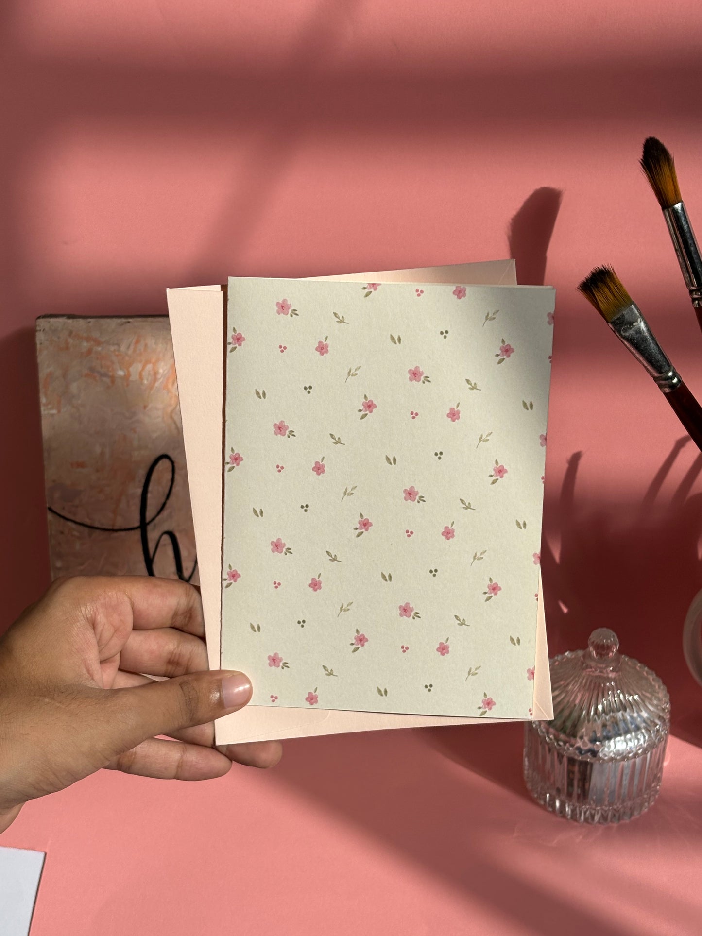 Pink floral greeting card styled with matching envelope