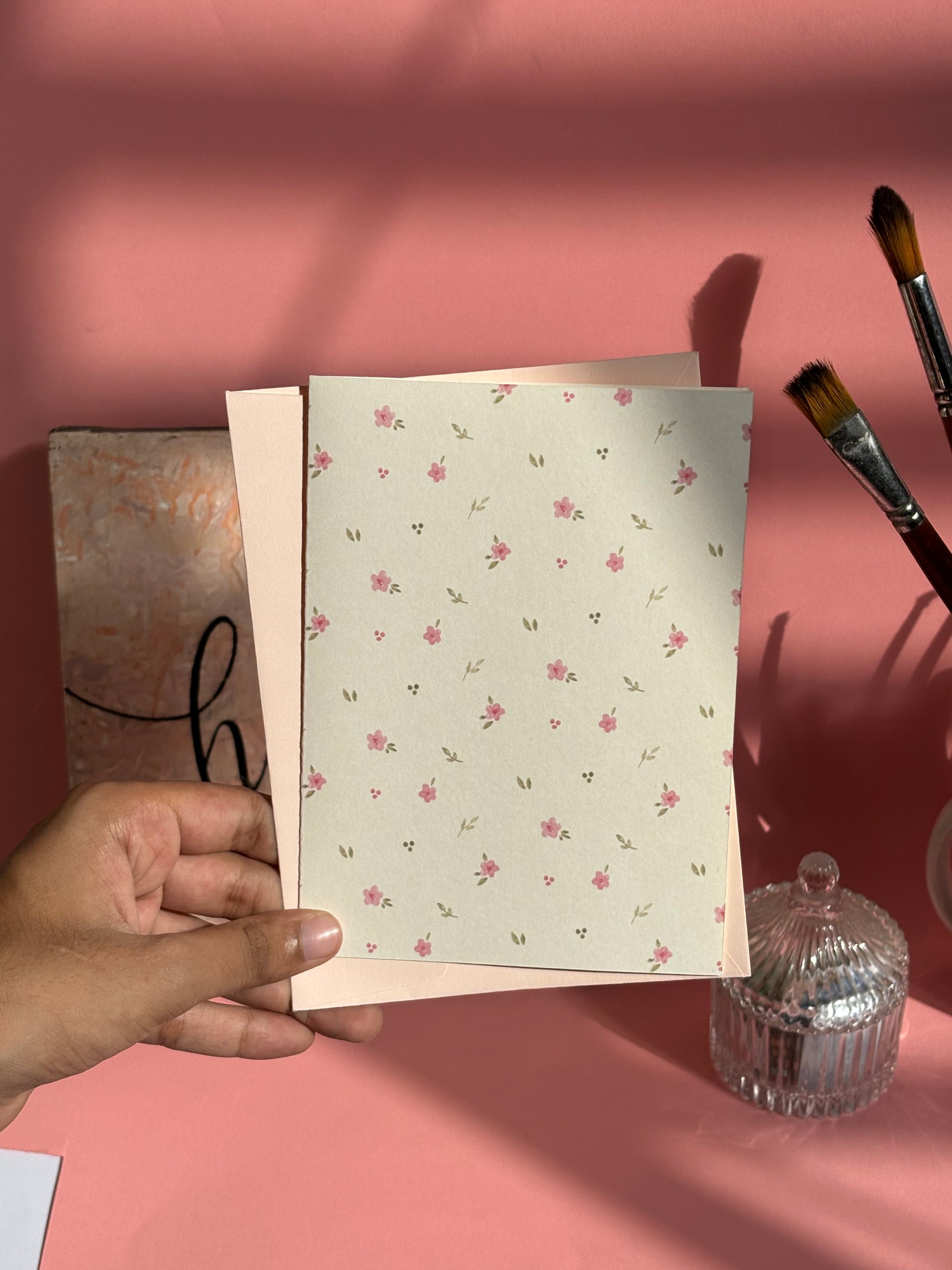 Pink floral greeting card styled with matching envelope