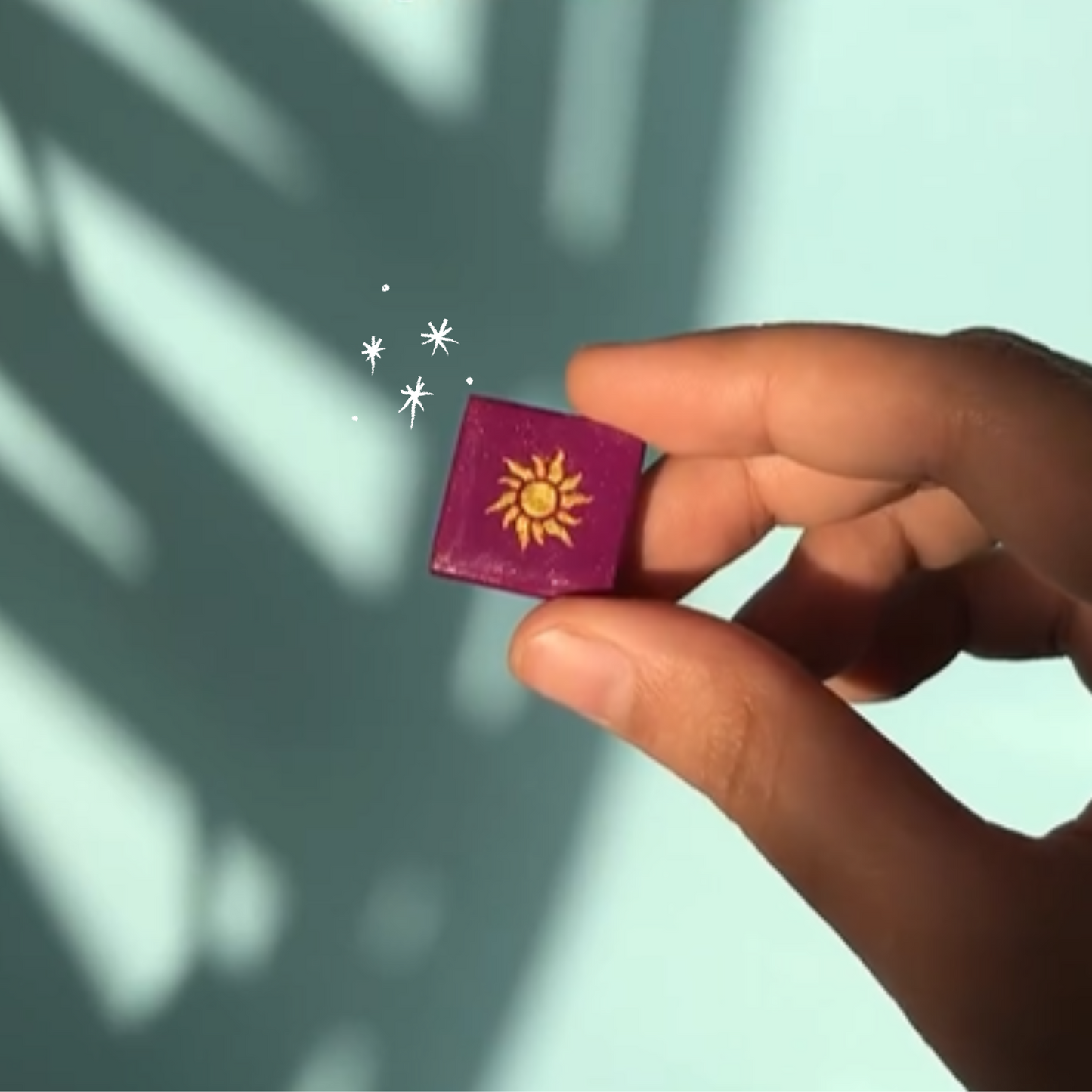 Tangled inspired handmade purple sun fridge magnet held in hand